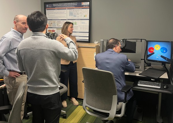 ESTCP Program Managers John La Scala works in a robotic surgery simulation in the Link Lab, while Tim Tetreault and Kim Spangler watch. 